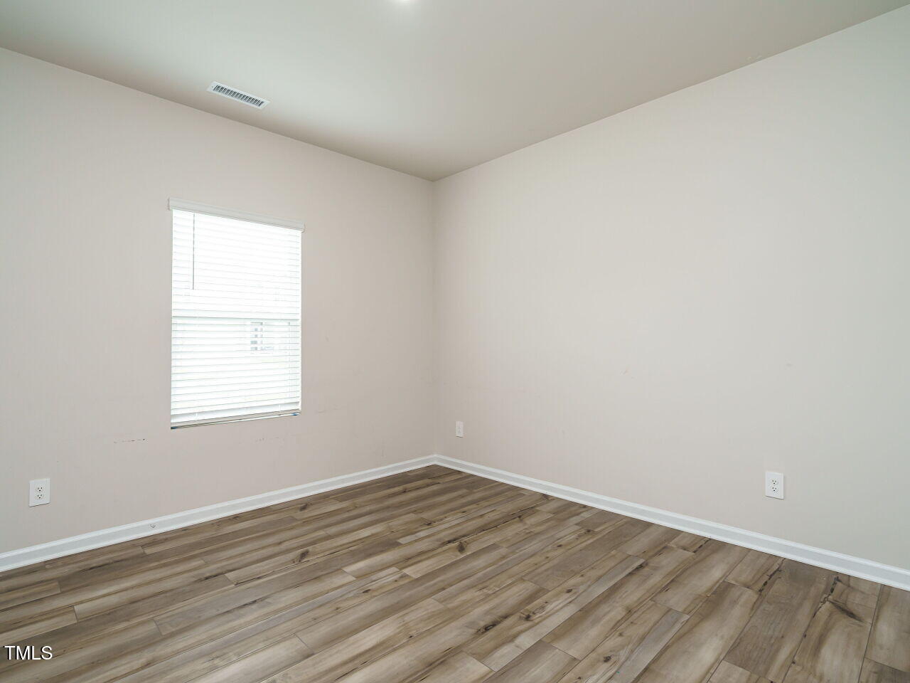 792 Riguard Way Wendell, NC 27591 - Photo 20 of 46 an empty room with wooden floor and windows