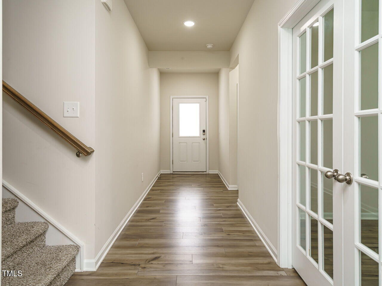 792 Riguard Way Wendell, NC 27591 - Photo 8 of 46 a view of a hallway with wooden floor and staircase
