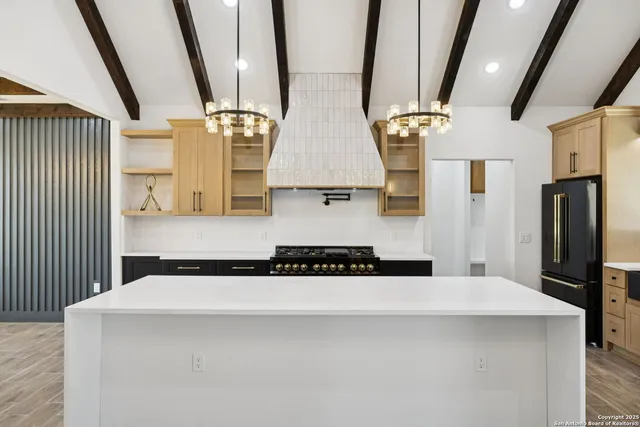 a kitchen with stainless steel appliances a sink and a refrigerator