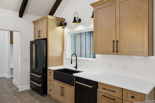 a kitchen with stainless steel appliances a refrigerator and cabinets