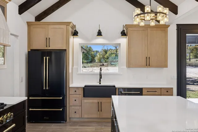 a kitchen with a refrigerator and a sink