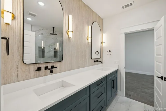 a bathroom with a double vanity sink mirror and bathtub