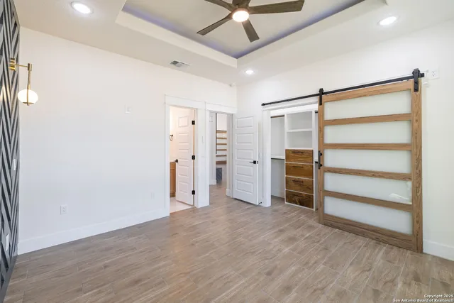 a view of walk in closet with empty racks