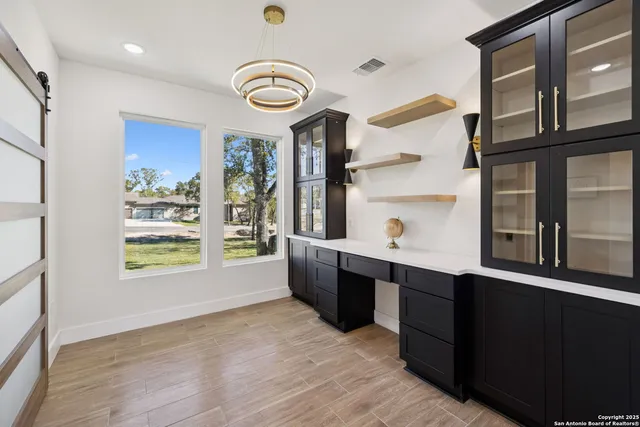 a kitchen with stainless steel appliances granite countertop a sink and a stove next to a large window