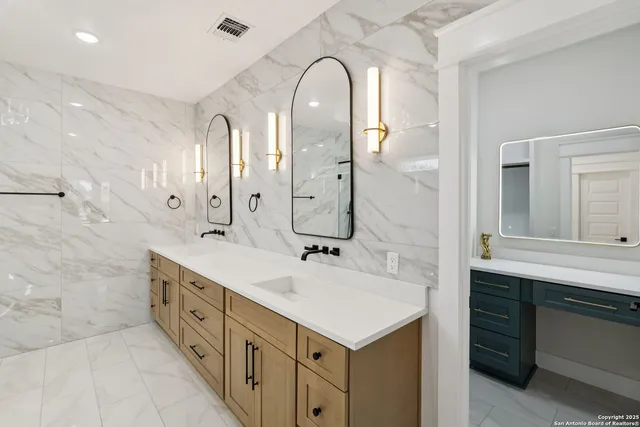 a bathroom with a double vanity sink mirror and