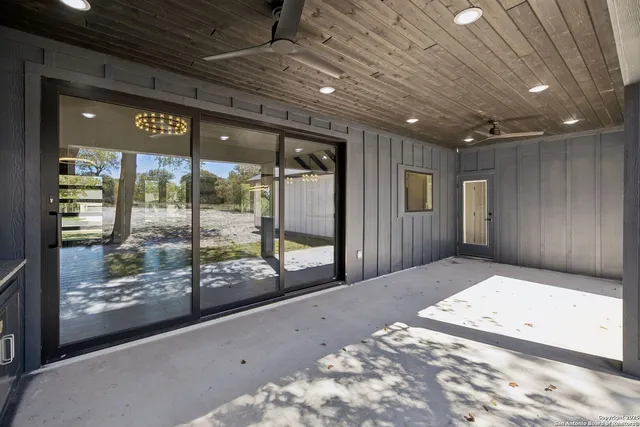 a view of a kitchen with a sink and wooden floor