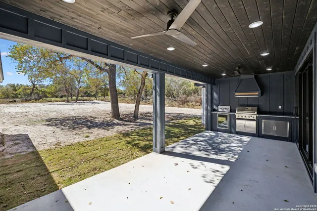 a kitchen with stainless steel appliances granite countertop sink stove refrigerator and cabinets