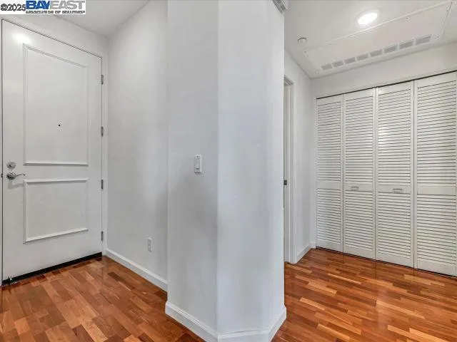 a dining room with furniture potted plants and wooden floor