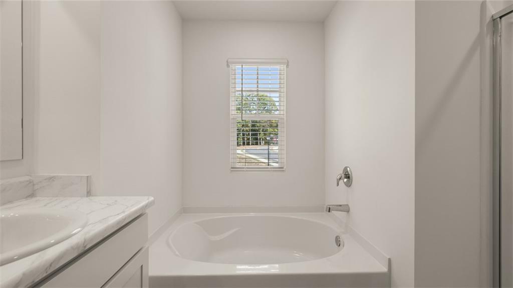 1910 Van Alen Court Dacula, GA 30019 - Photo 17 of 64 a white bath tub sitting next to a white sink