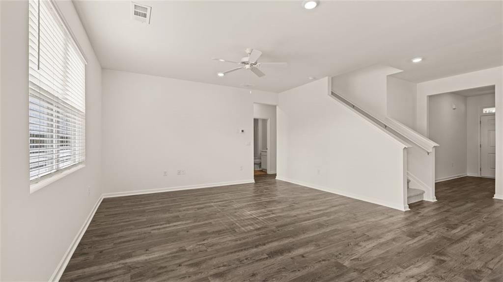 1910 Van Alen Court Dacula, GA 30019 - Photo 22 of 64 a view of an empty room with wooden floor and a window