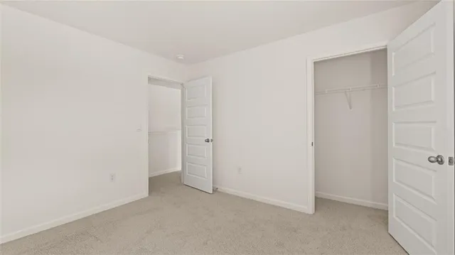 a large bed sitting in a bedroom and lamp