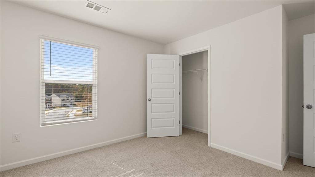 1910 Van Alen Court Dacula, GA 30019 - Photo 32 of 64 a view of an empty room with a window