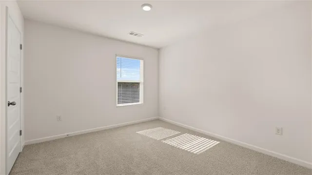 a bathroom with a shower and a glass door