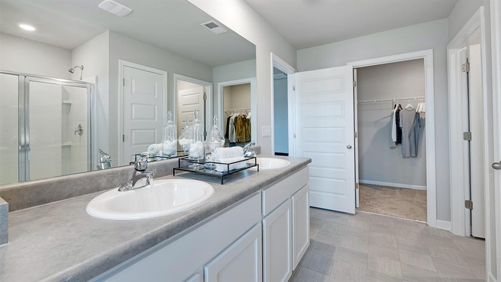 1910 Van Alen Court Dacula, GA 30019 - Photo 42 of 64 a bathroom with a sink double vanity and a mirror