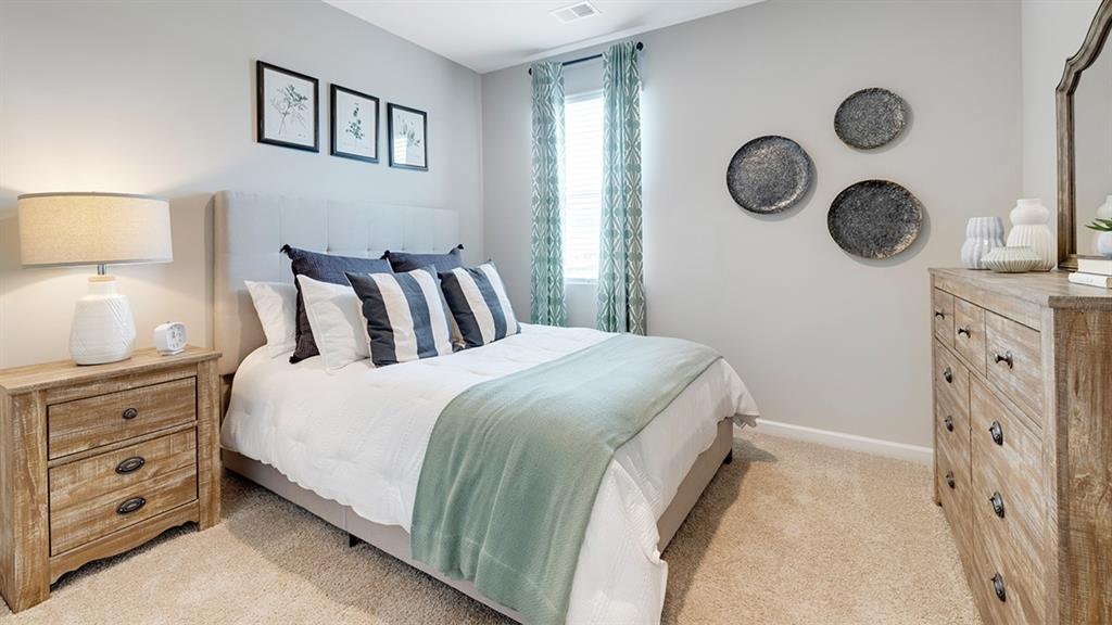 1910 Van Alen Court Dacula, GA 30019 - Photo 48 of 64 a bedroom with a bed and a lamp on dresser next to a window