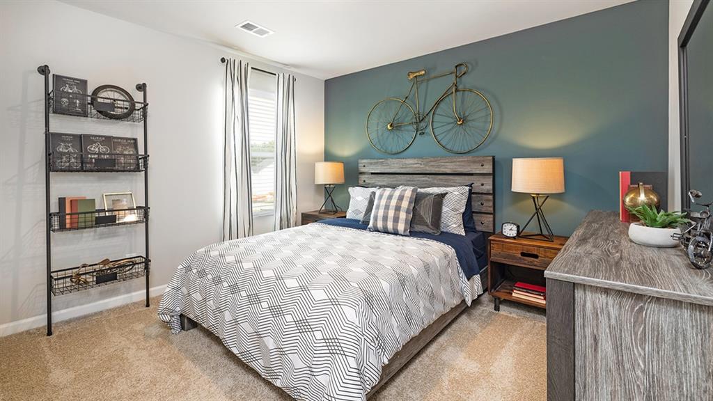 1910 Van Alen Court Dacula, GA 30019 - Photo 57 of 64 a bedroom with a bed and wooden floor