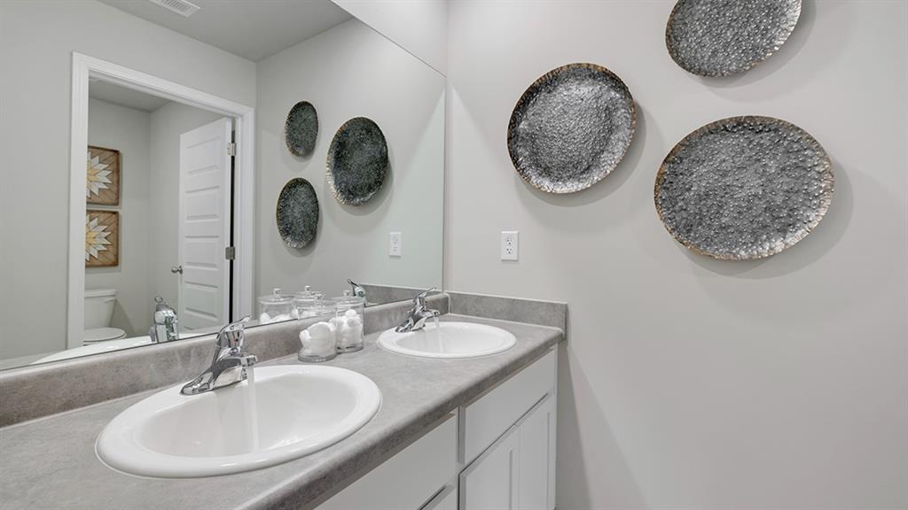 1910 Van Alen Court Dacula, GA 30019 - Photo 59 of 64 a bathroom with a double vanity and a mirror