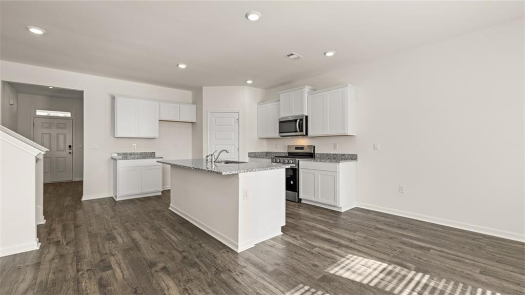 1910 Van Alen Court Dacula, GA 30019 - Photo 8 of 64 a kitchen with a refrigerator and a stove top oven