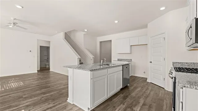 a bathroom with a sink double vanity granite tub and mirror