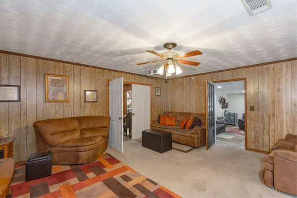 a living room with furniture and a chandelier
