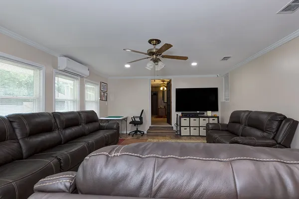 a living room with furniture and a flat screen tv