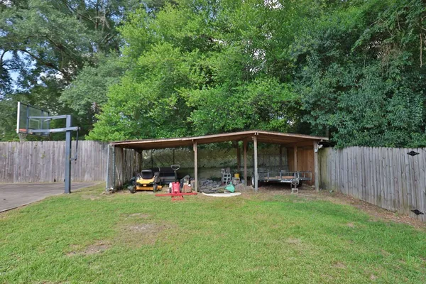 a view of outdoor space with deck and trampoline