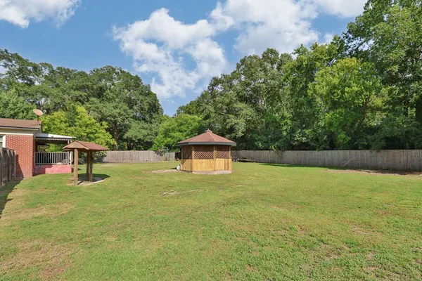 a backyard of a house with table and chairs