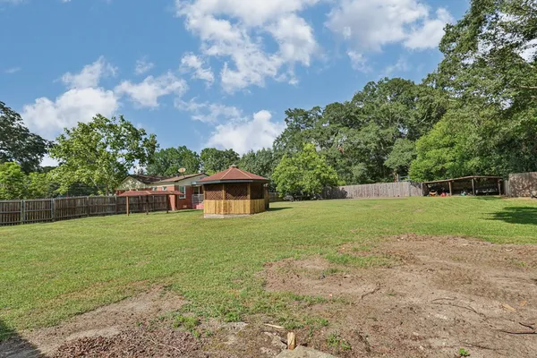 a view of a house with a backyard
