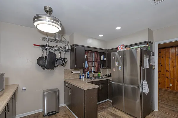 a kitchen with refrigerator and cabinets