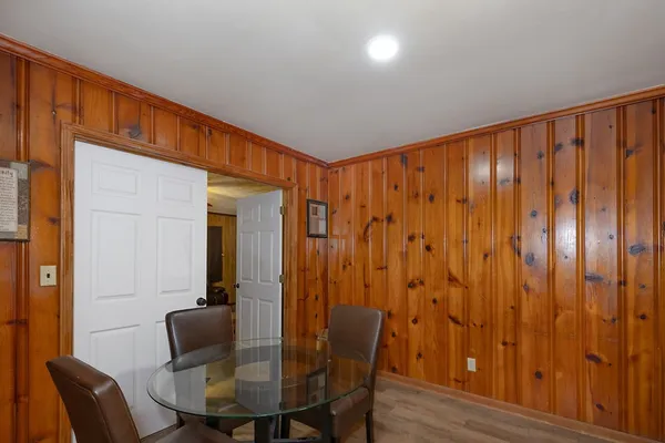 a view of a hallway with furniture and wooden floor