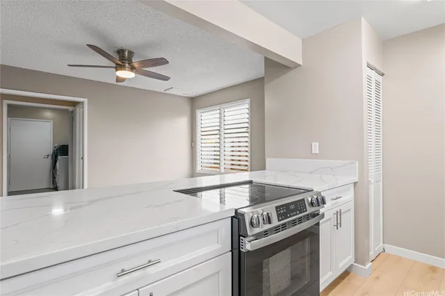 a kitchen with a stove and a white cabinets