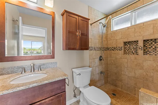 a bathroom with a granite countertop sink toilet a mirror and shower