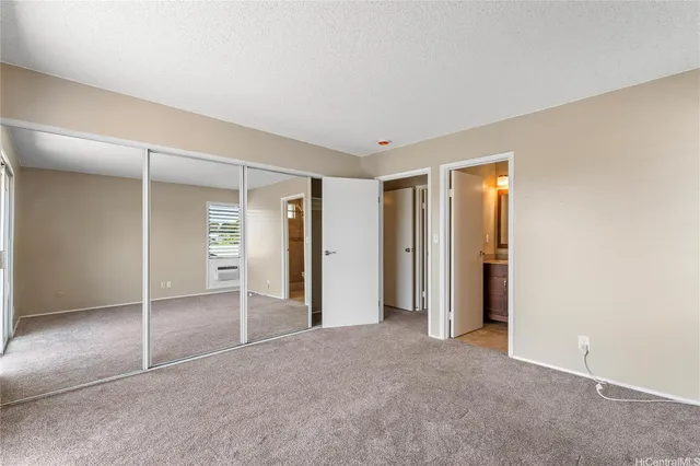 an empty room with closet and bathroom