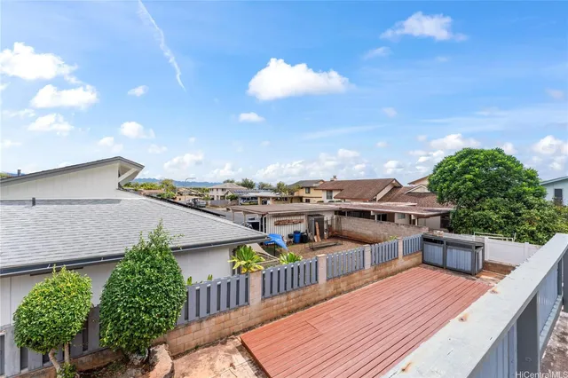 a balcony with wooden floor and city view
