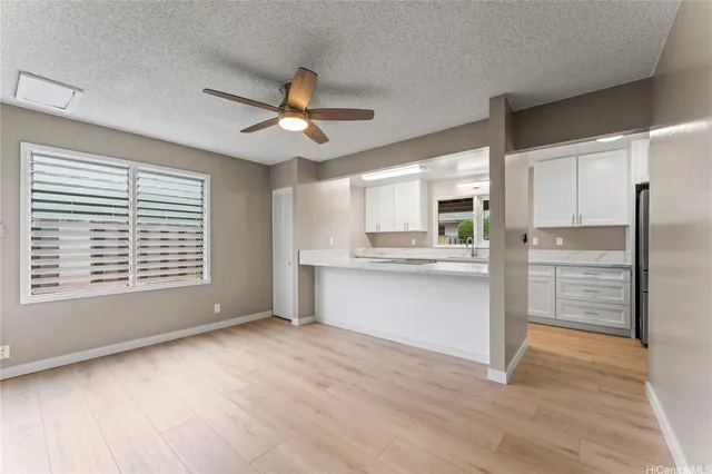 a kitchen with stainless steel appliances a refrigerator and a stove top oven