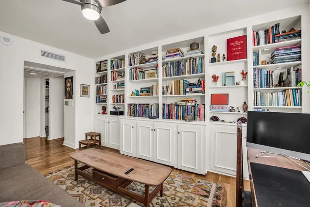 a bathroom with a granite countertop shower sink vanity and mirror