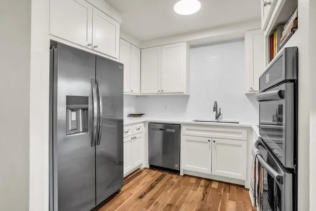 a kitchen with stainless steel appliances a refrigerator stove and sink