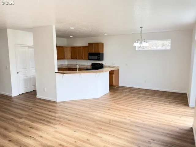 a view of kitchen with microwave and cabinets