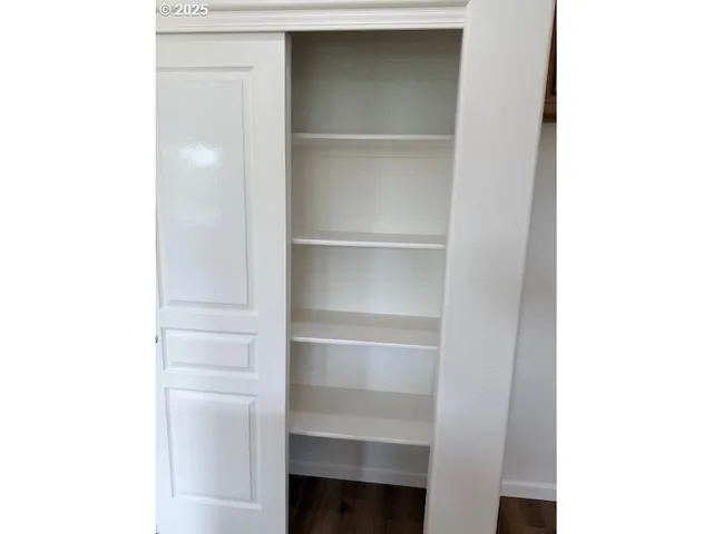 a view of walk in closet with empty racks