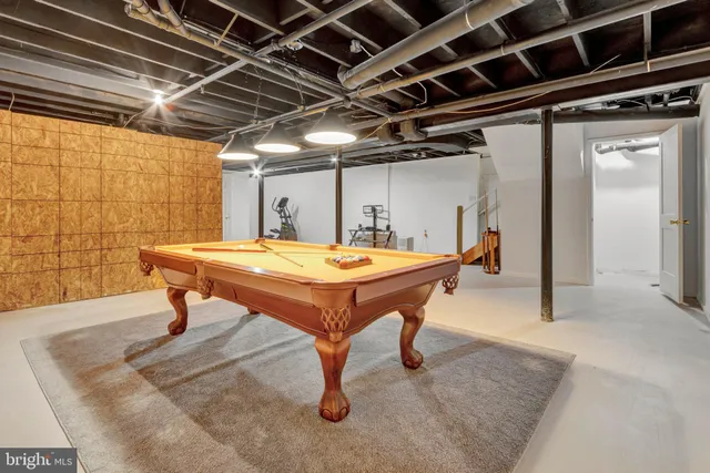 a room with pool table and windows