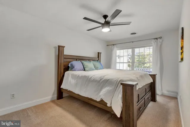 a bed sitting in a bedroom next to a window