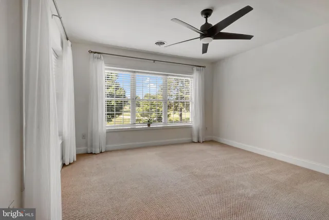 a view of room with a ceiling fan and window