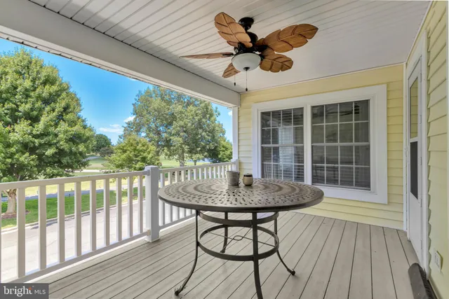 a view of a balcony with furniture and wooden floor