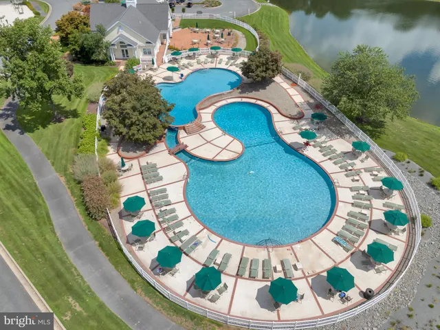 an aerial view of a swimming pool with a swimming pool