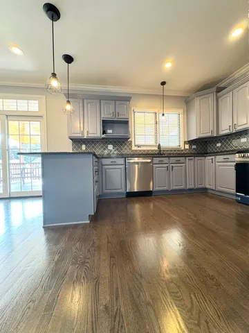 a large kitchen with lots of counter space and a sink