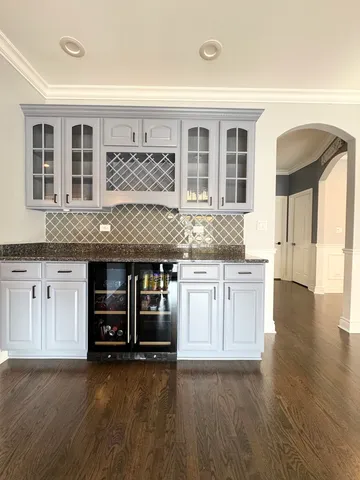 a kitchen with granite countertop a stove and a wooden cabinets