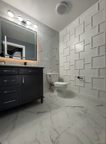 a bathroom with a sink a toilet and mirror