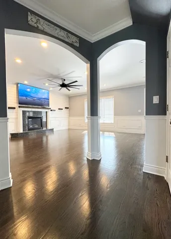 a view of empty room with wooden floor