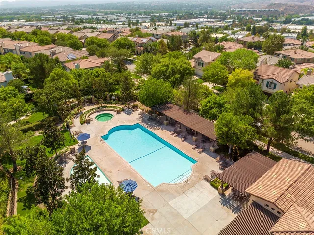 an aerial view of a house with a yard and lake view