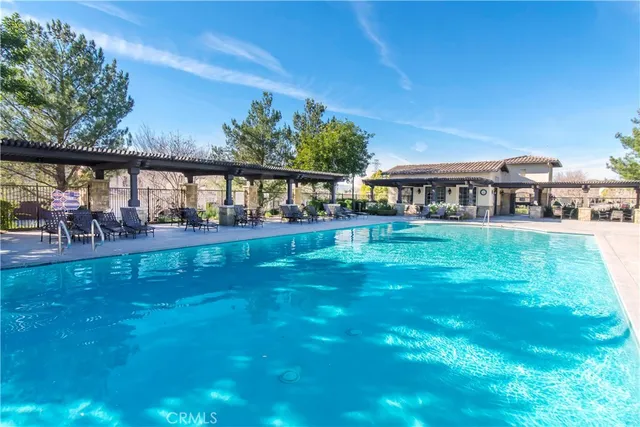 an aerial view of a house with a yard and lake